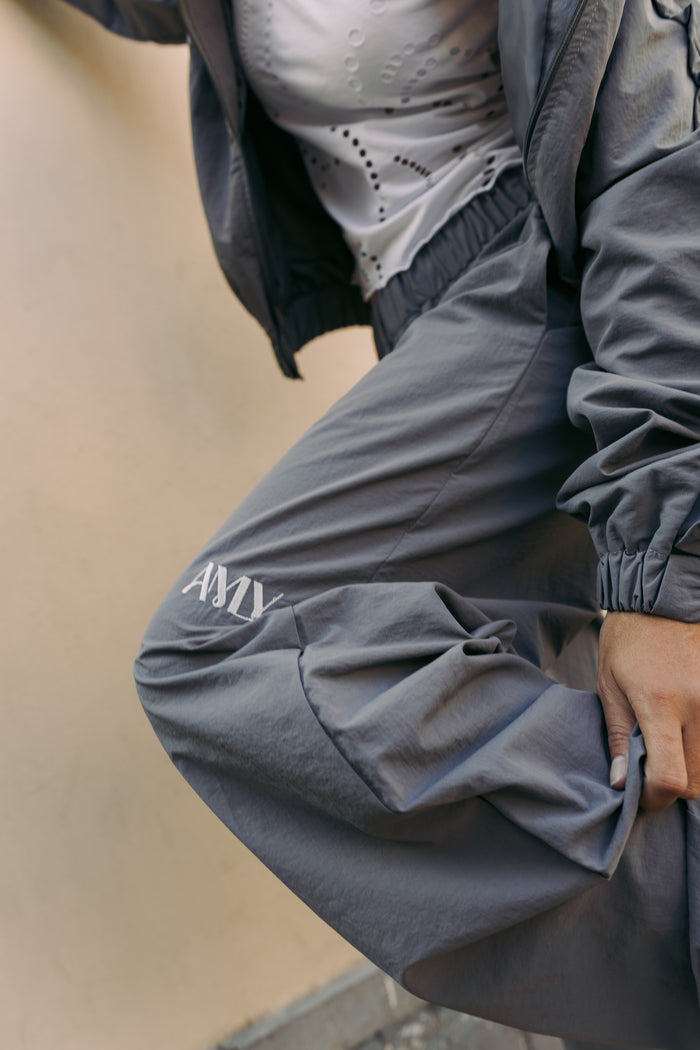 AMLY logo on the slate grey trousers