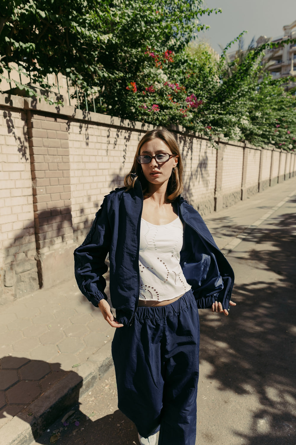Navy jacket worn open over a white top