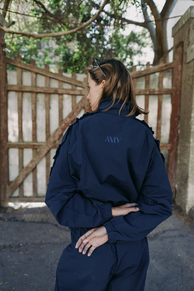 AMLY logo on the back of the navy jacket