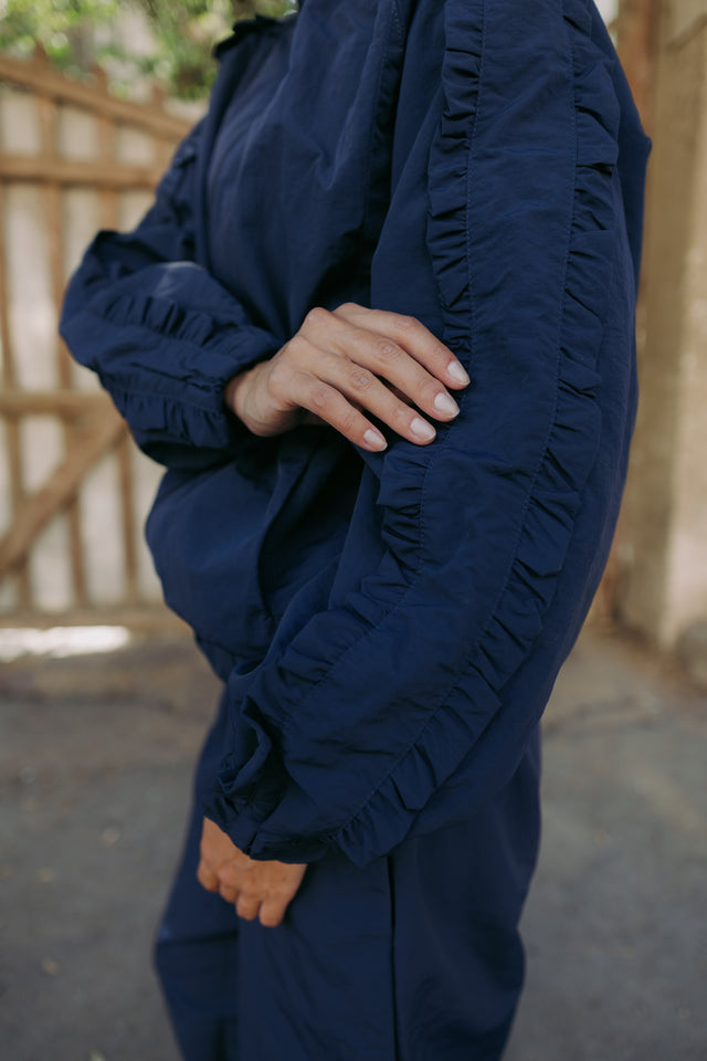 Ruffle trim on the navy sleeve